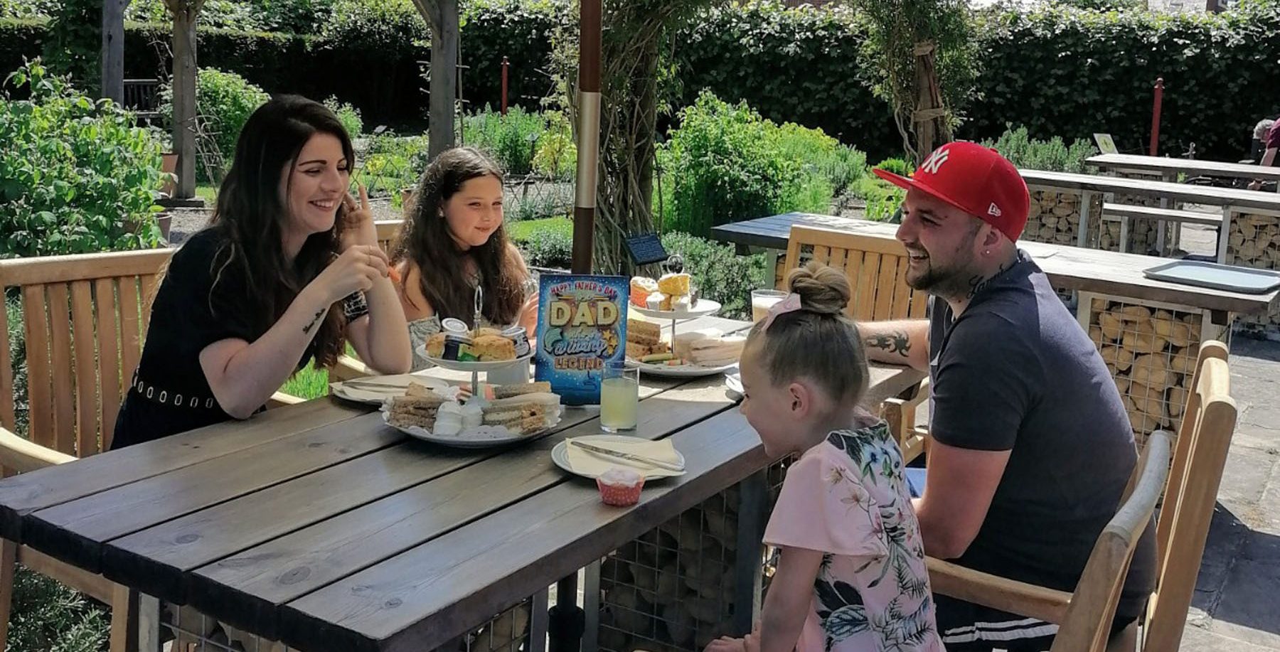 Photo Of Family Having Afternoon Tea On Patio Aspect Ratio 785 400